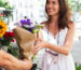 close-up-smiley-woman-holding-flowers (1)